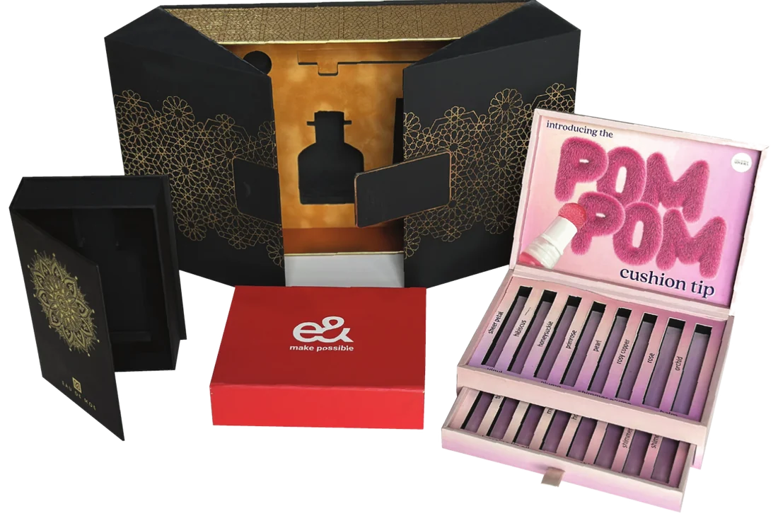 Rigid gift boxes with gold foil pattern work and a fitted cosmetics palette box