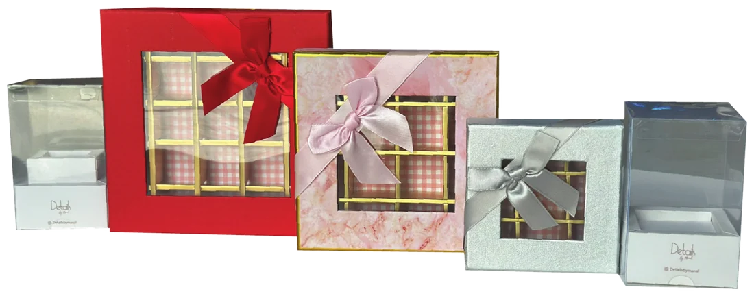 Sweet and chocolate gift boxes with ribbons, windows and gold dividers